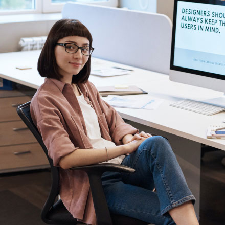 Woman Sitting on Chair at a Desk